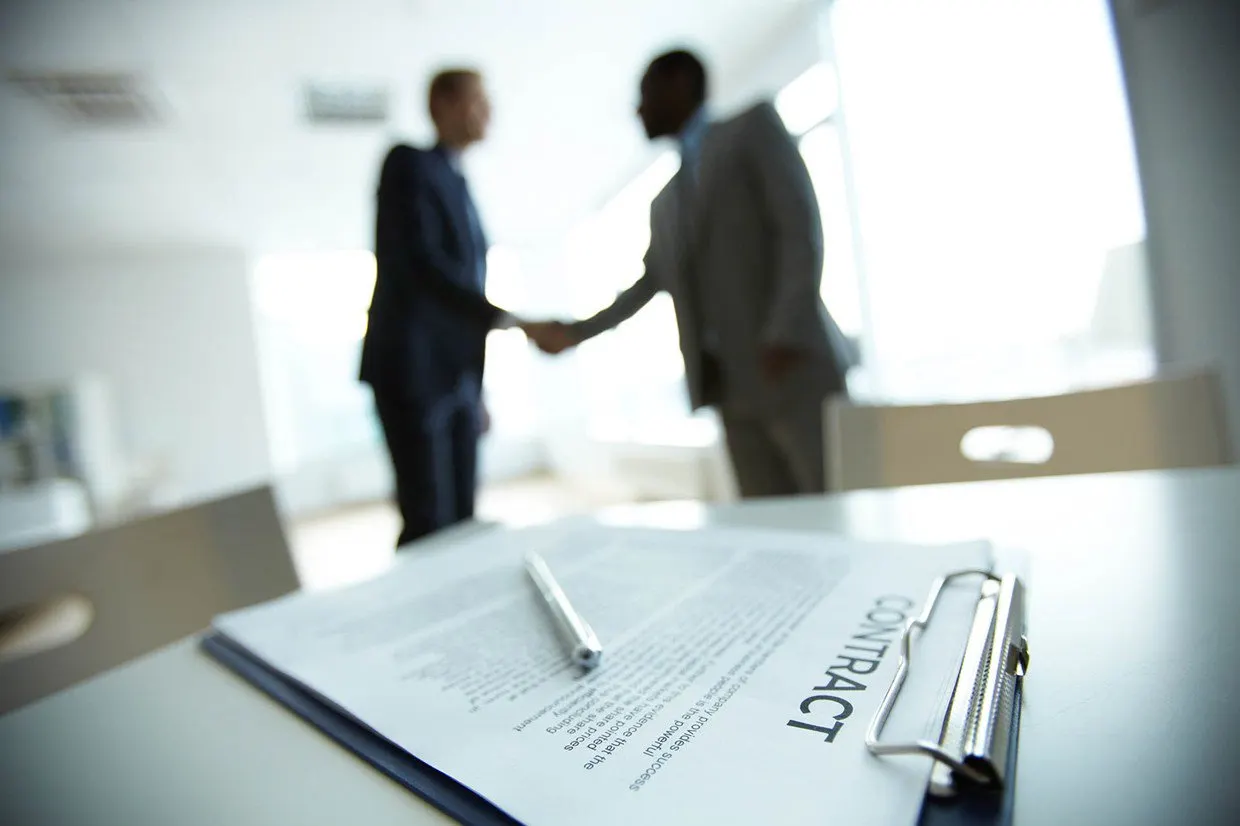 Executive hands indicating where to sign contract